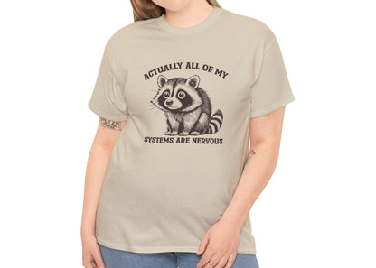 Model wearing a beige T-shirt with "Actually All Of My Systems Are Nervous" text and a raccoon graphic. Part of the Vivid Divergence Sensory Friendly Unisex Tees Range.
