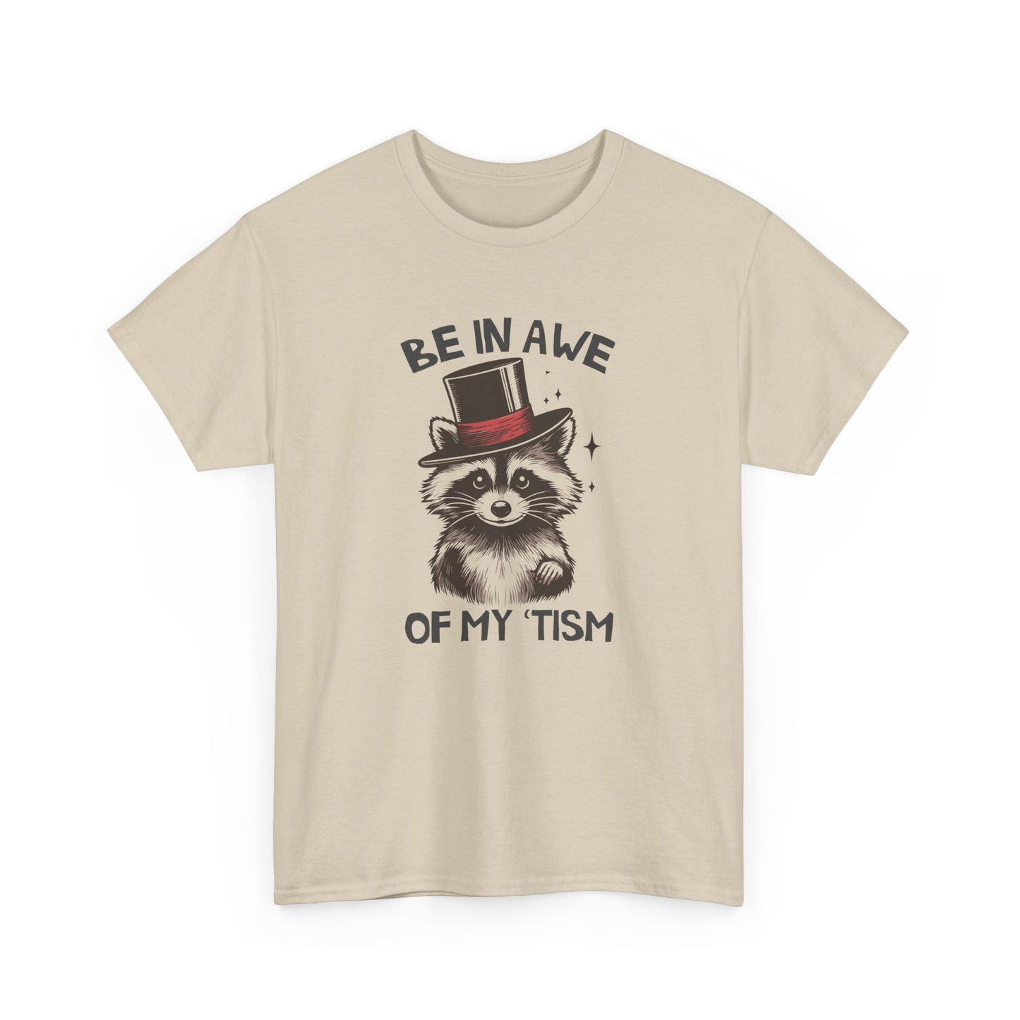 Front view of a beige T-shirt featuring a raccoon wearing a top hat with the text "Be In Awe Of My Tism." Part of the Vivid Divergence Sensory Friendly Unisex Tees Range.