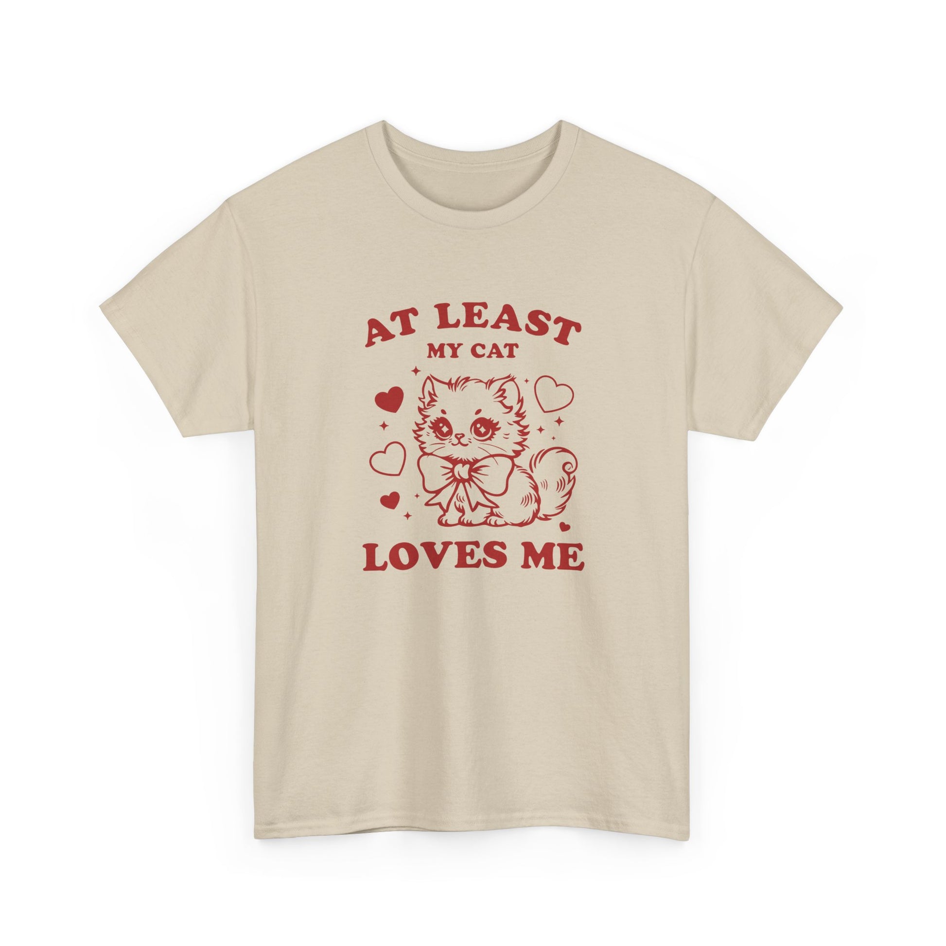 Front view of a beige T-shirt with red text and cat illustration that reads "At Least My Cat Loves Me." Exclusive release for Valentine’s Day. Part of the Vivid Divergence Sensory Friendly Unisex Tees Range.