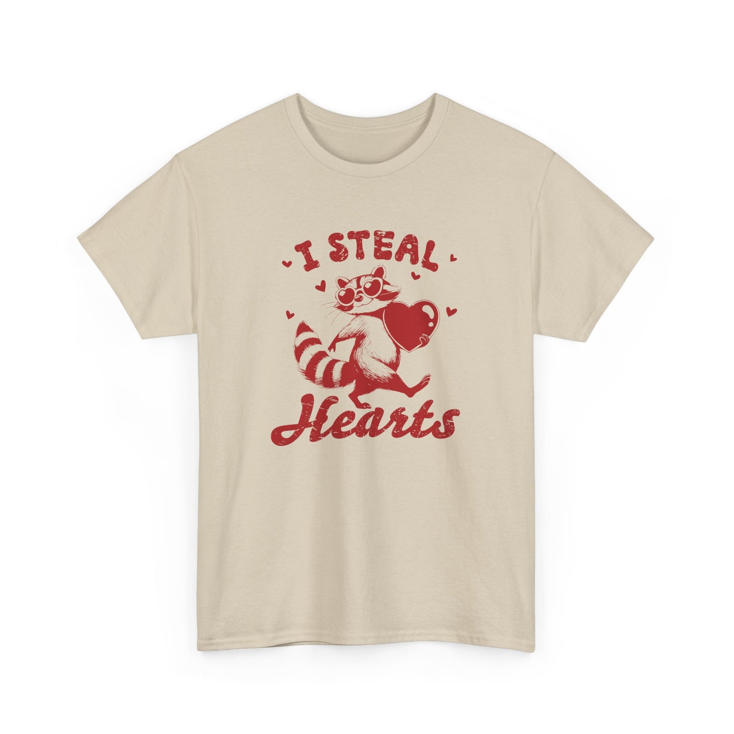 Front view of a beige T-shirt with red text and raccoon illustration holding a heart that reads "I Steal Hearts." Exclusive release for Valentine’s Day. Part of the Vivid Divergence Sensory Friendly Unisex Tees Range.