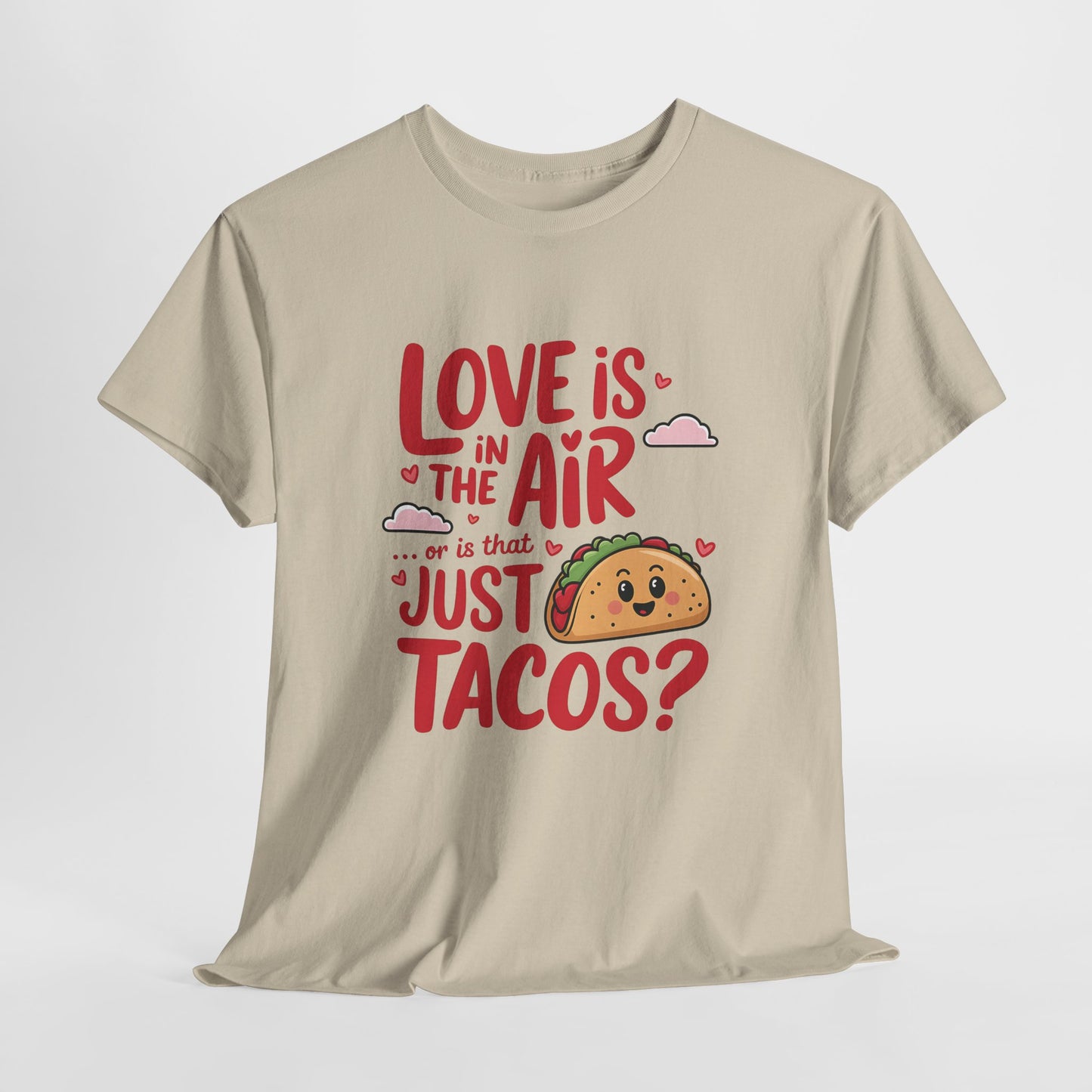 Hanging beige T-shirt featuring red and black text with a taco illustration that reads "Love Is In The Air Or Is It Just Tacos?" Exclusive release for Valentine’s Day. Part of the Vivid Divergence Sensory Friendly Unisex Tees Range.