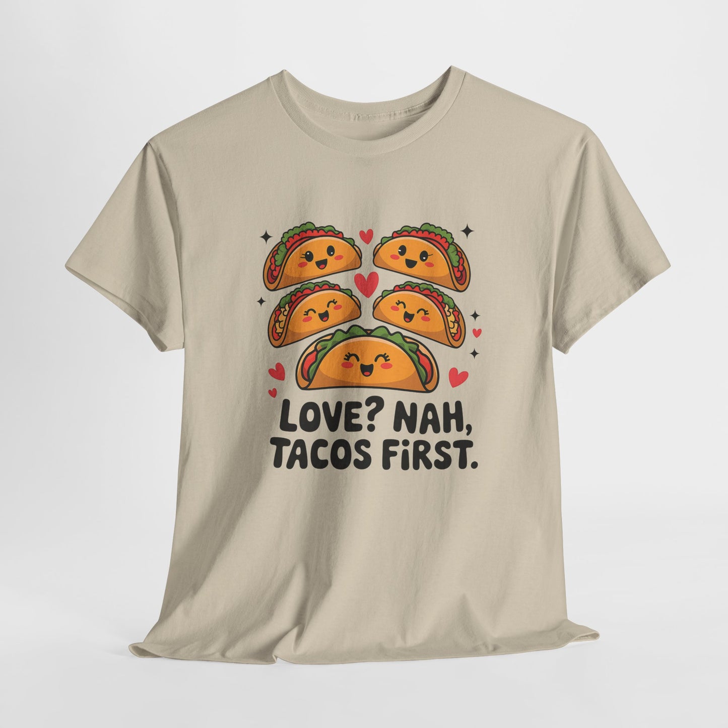 Hanging beige T-shirt featuring an illustration of tacos and black text that reads "Love? Nah, Tacos First." Exclusive release for Valentine’s Day. Part of the Vivid Divergence Sensory Friendly Unisex Tees Range.