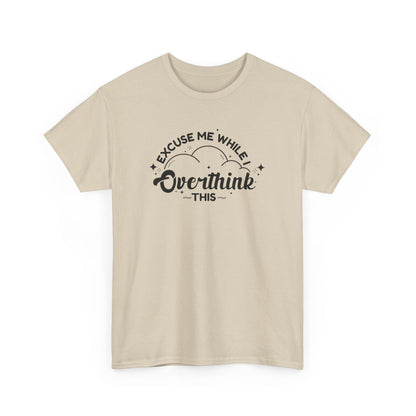 Front view of a beige T-shirt with the text "Excuse Me While I Overthink This" in a playful font. Part of the Vivid Divergence Sensory Friendly Unisex Tees Range.