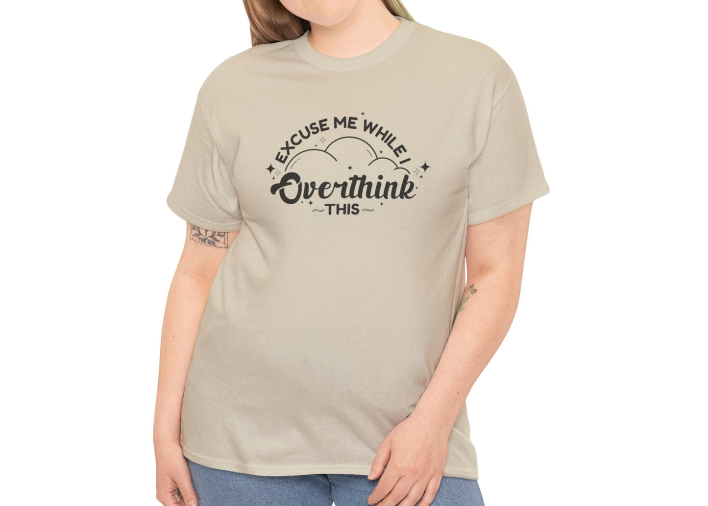 Woman modeling a beige T-shirt with the text "Excuse Me While I Overthink This." Part of the Vivid Divergence Sensory Friendly Unisex Tees Range.