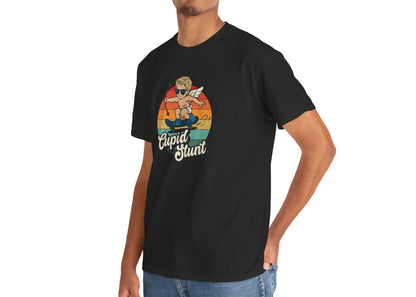 Man wearing a black T-shirt featuring a retro sunset background and a cartoon cupid with the text "Cupid Stunt." Exclusive release for Valentine’s Day. Part of the Vivid Divergence Sensory Friendly Unisex Tees Range.