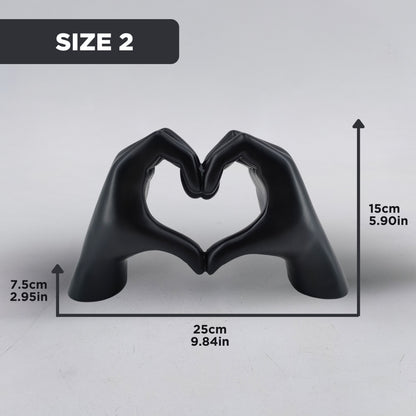 Black hand-shaped sculpture forming a heart with dimensions of 15 cm height, 25 cm width, and 7.5 cm depth for Size 2 selection. Elegant dopamine decor and an ideal gift for Valentine's Day.