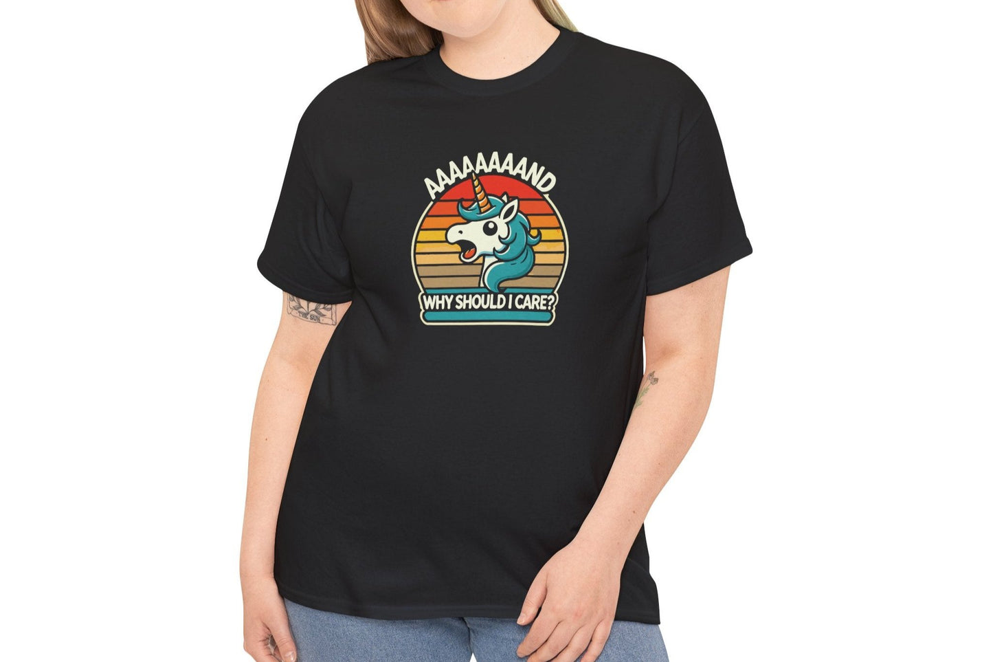 Model wearing a black T-shirt with a "Aaaaand Why Should I Care?" text and unicorn rainbow retro graphic. Part of the Vivid Divergence Sensory Friendly Unisex Tees Range.