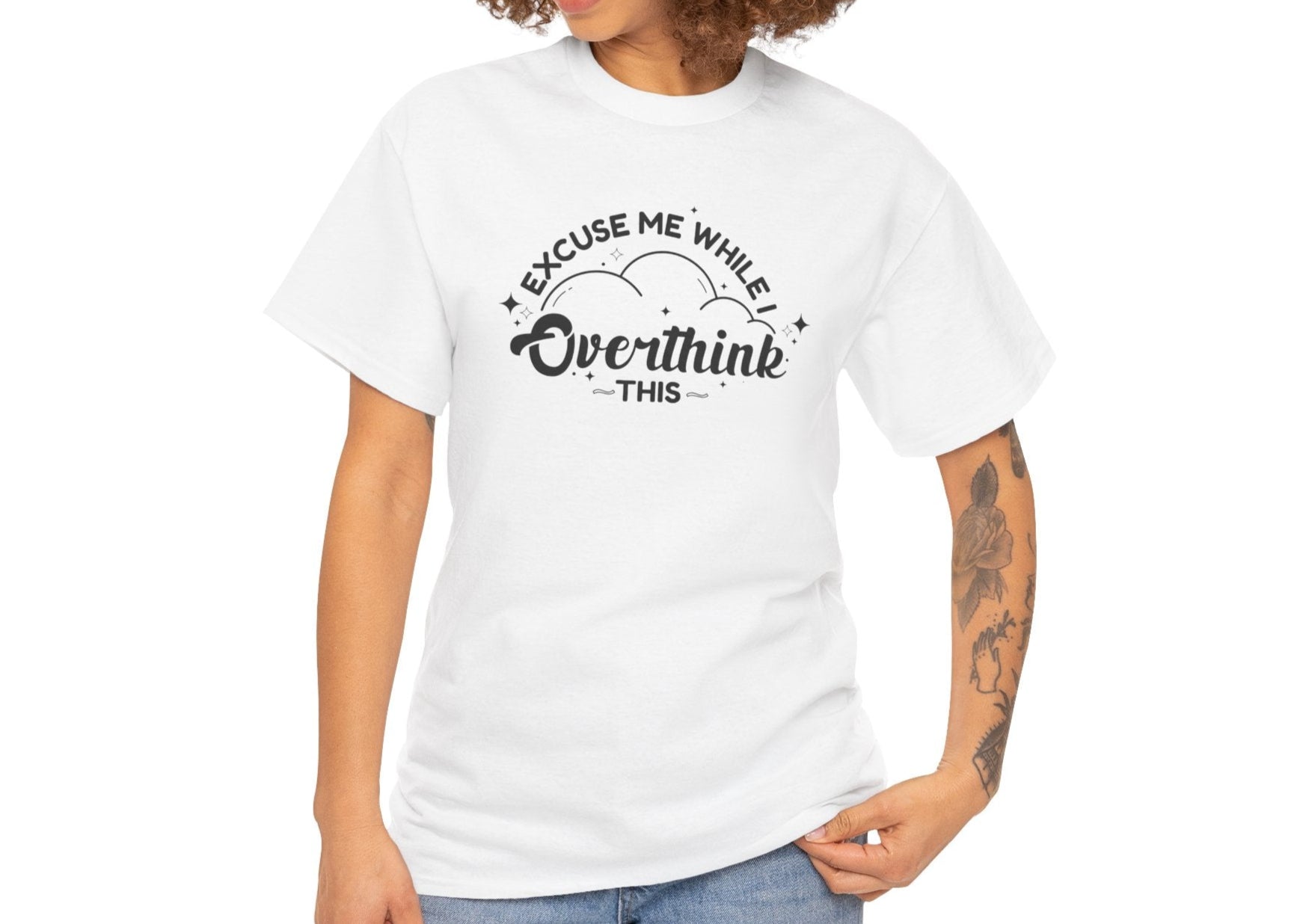 Close-up of a person wearing a white T-shirt with the text "Excuse Me While I Overthink This." Part of the Vivid Divergence Sensory Friendly Unisex Tees Range.