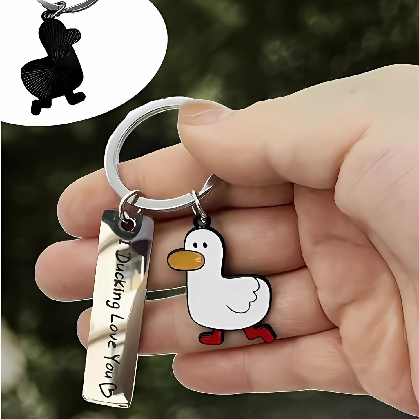 Duck-themed keychain held in a hand, featuring a white duck charm with red boots and a shiny silver tag engraved with "I Ducking Love You ♥."