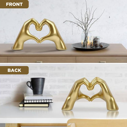 Front and back view of a gold hand-shaped sculpture forming a heart on a console table. A stylish addition to dopamine decor and a thoughtful Valentine's Day gift.