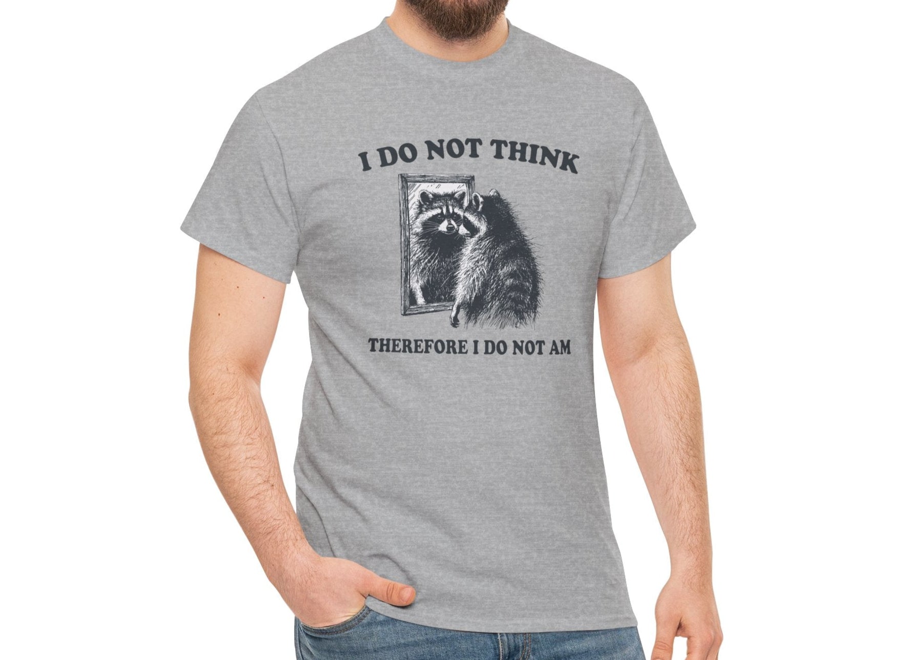 A gray T-shirt with a raccoon illustration and existential quote, modeled by a man. Part of the Vivid Divergence Sensory Friendly Unisex Tees Range.