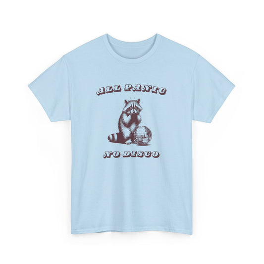 Front view of a light blue T-shirt featuring the text "All Panic No Disco" with a raccoon illustration. Part of the Vivid Divergence Sensory Friendly Unisex Tees Range.