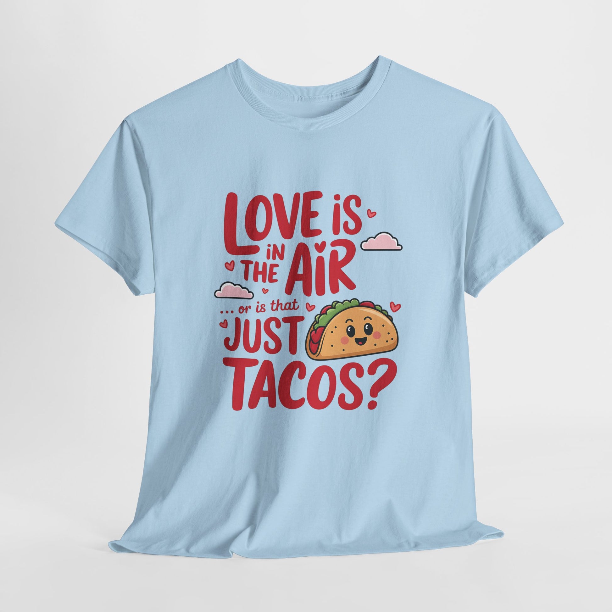 Hanging light blue T-shirt featuring red and black text with a taco illustration that reads "Love Is In The Air Or Is It Just Tacos?" Exclusive release for Valentine’s Day. Part of the Vivid Divergence Sensory Friendly Unisex Tees Range.