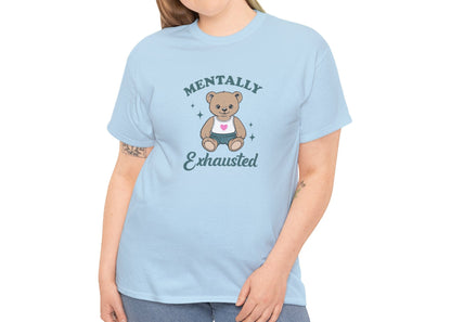 Modeled view of a light blue T-shirt featuring a teddy bear graphic with the text "Mentally Exhausted." Part of the Vivid Divergence Sensory Friendly Unisex Tees Range.