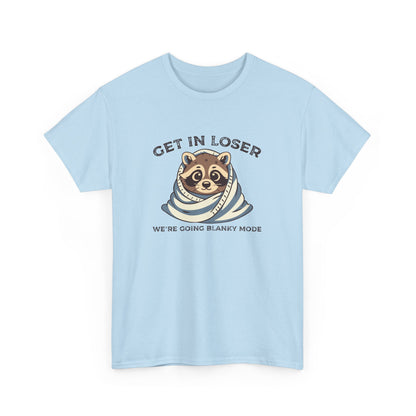 Hanging front view of a light blue T-shirt featuring a cute raccoon wrapped in a blanket with text that reads "Get In Loser, We're Going Blanky Mode." Part of the Vivid Divergence Sensory Friendly Unisex Tees Range.