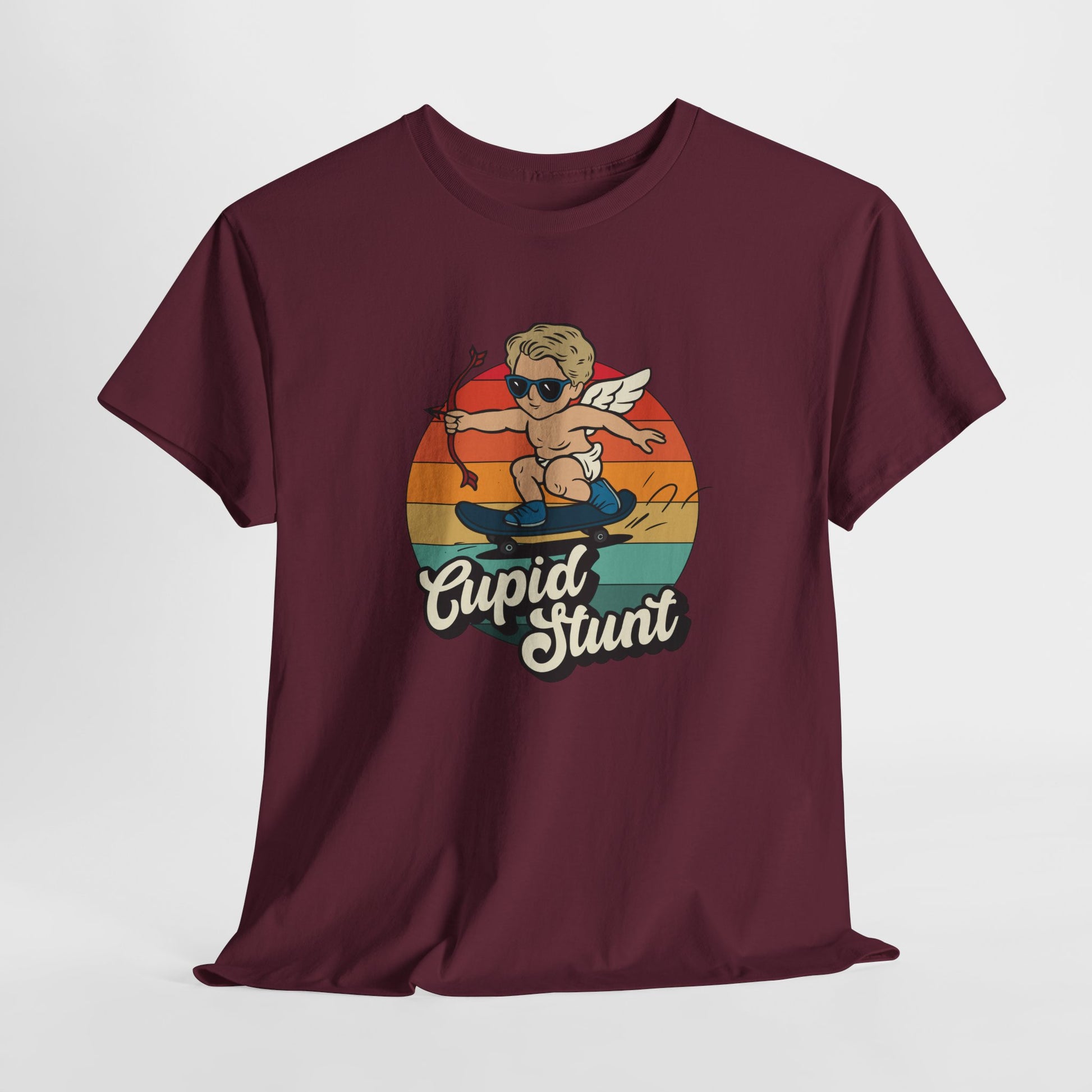 Hanging maroon T-shirt featuring a retro sunset background and a cartoon cupid with the text "Cupid Stunt." Exclusive release for Valentine’s Day. Part of the Vivid Divergence Sensory Friendly Unisex Tees Range.