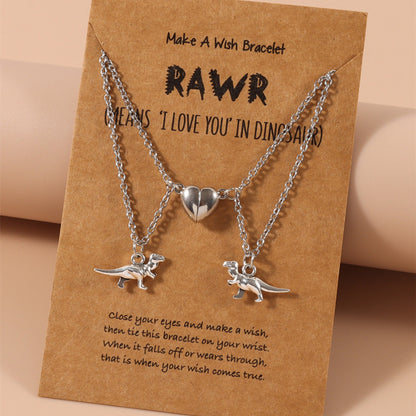 Magnetic dinosaur-themed matching necklaces on a “Make A Wish” card with sentimental messaging. A unique couples necklace.