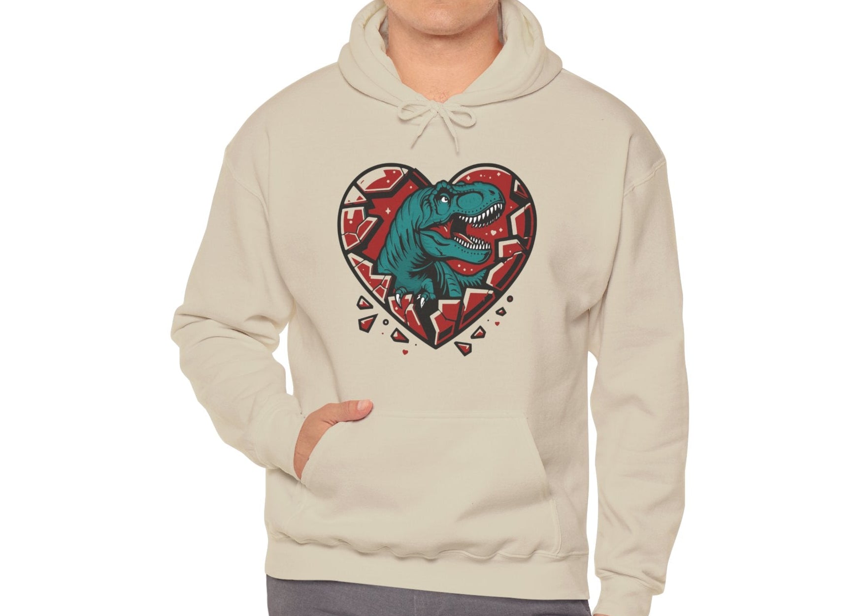 Model wearing a beige hoodie with a shattered heart design featuring a T-Rex emerging from the center in vibrant teal and red tones. Exclusive release for Valentine's Day. Part of the Vivid Divergence Sensory Friendly Sweaters Range.