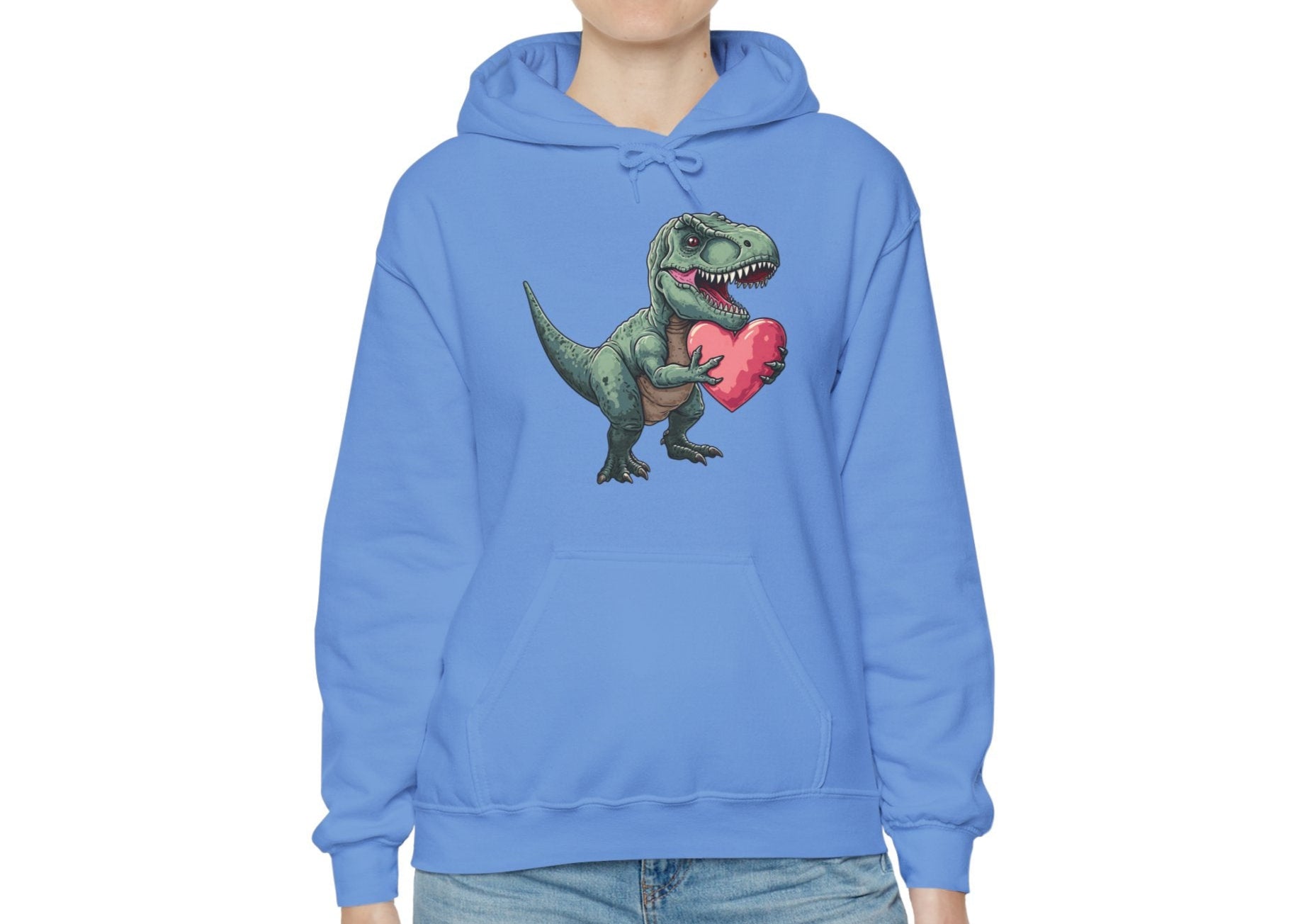 Model wearing a blue hoodie featuring a cute cartoon T-Rex holding a pink heart. Exclusive release for Valentine's Day. Part of the Vivid Divergence Sensory Friendly Sweaters Range.