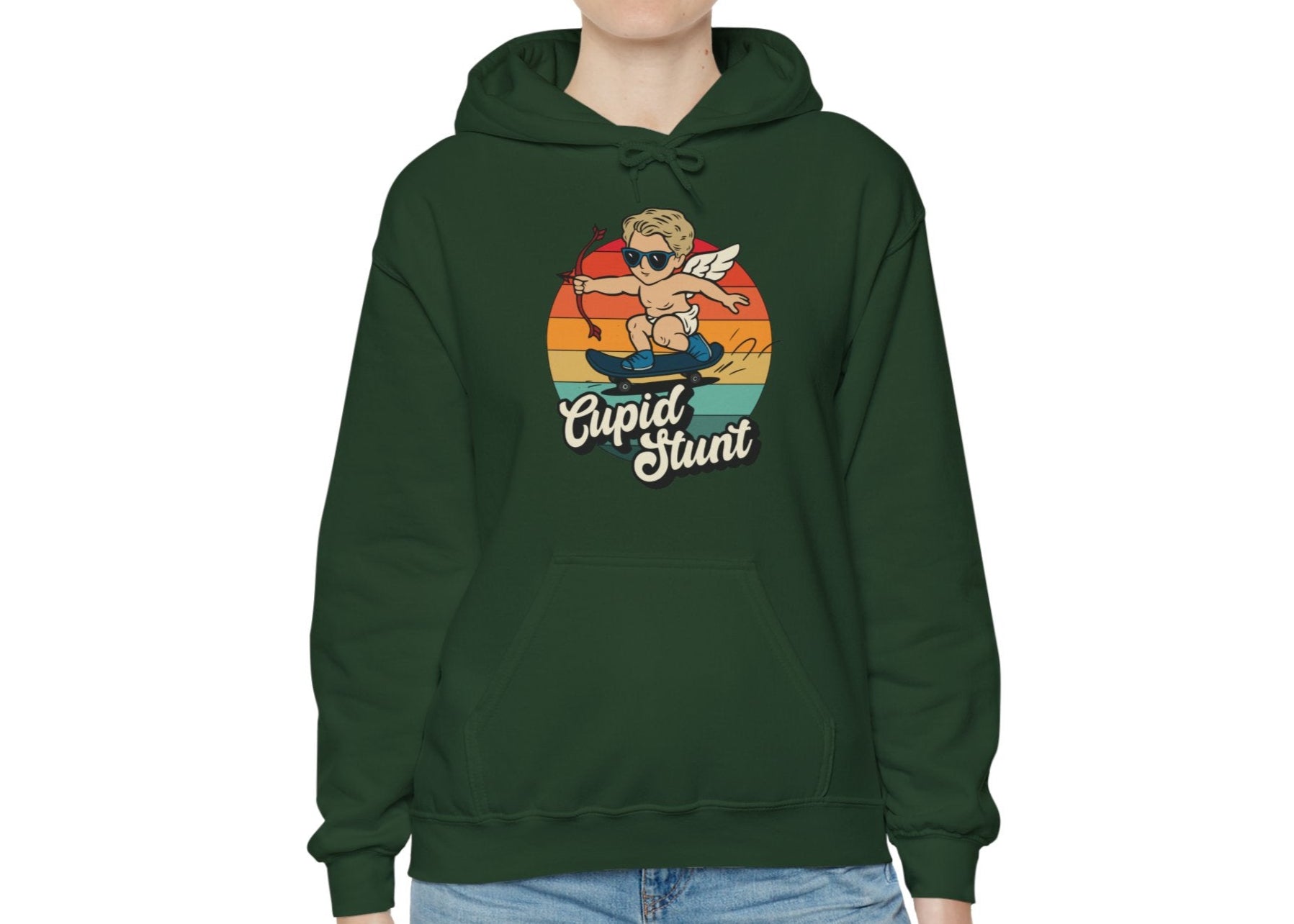 Model wearing a green hoodie with a vintage sunset design featuring Cupid riding a skateboard and "Cupid Stunt" text. Exclusive release for Valentine's Day. Part of the Vivid Divergence Sensory Friendly Sweaters Range.