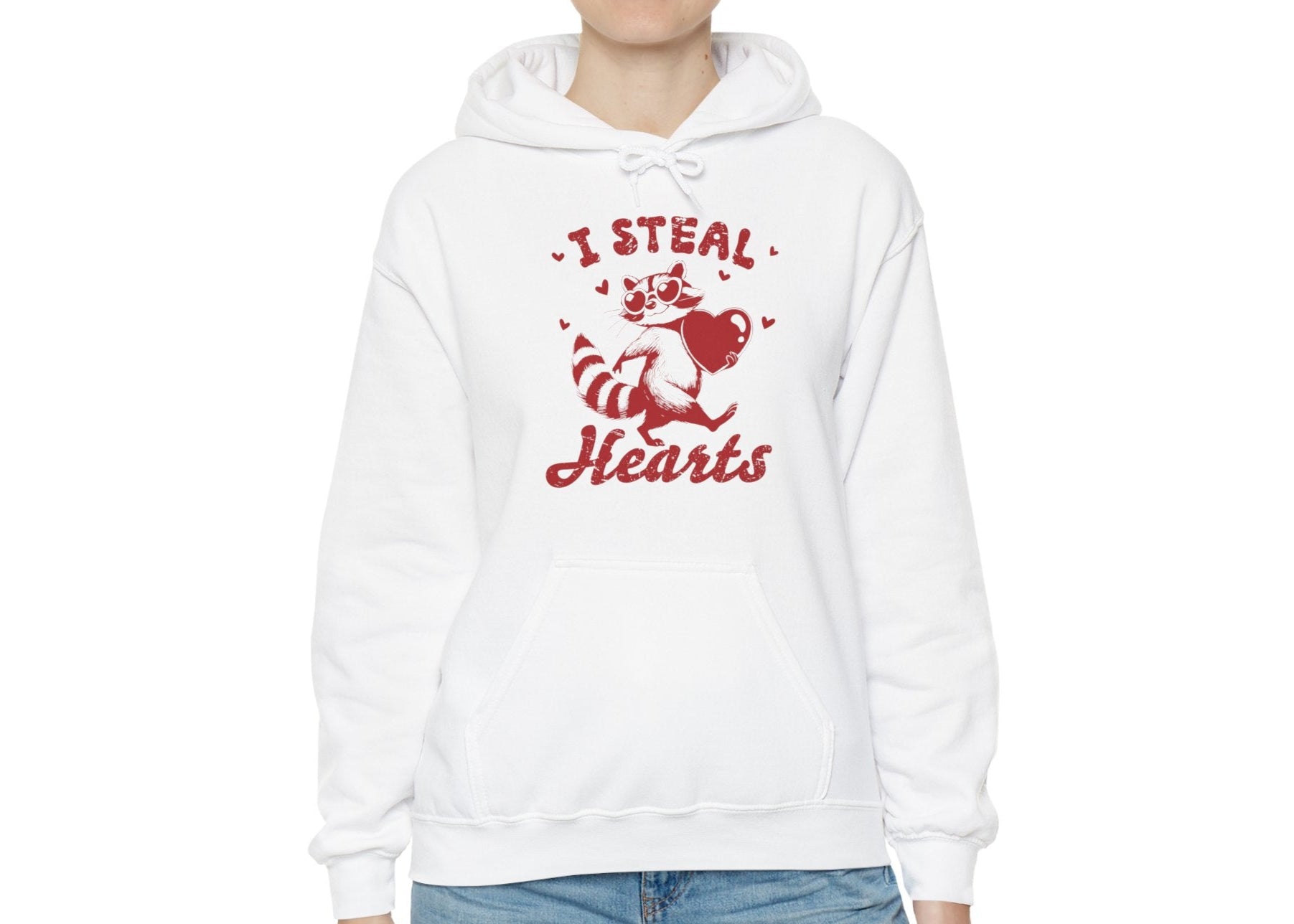 Model wearing a white hoodie with "I Steal Hearts" text and a cute red Cupid design holding a bow and arrow. Exclusive release for Valentine's Day. Part of the Vivid Divergence Sensory Friendly Sweaters Range.