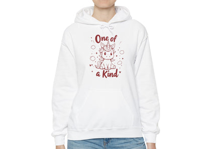 Model wearing a white hoodie featuring "One of a Kind" text and a cute unicorn design in red. Exclusive release for Valentine's Day. Part of the Vivid Divergence Sensory Friendly Sweaters Range.