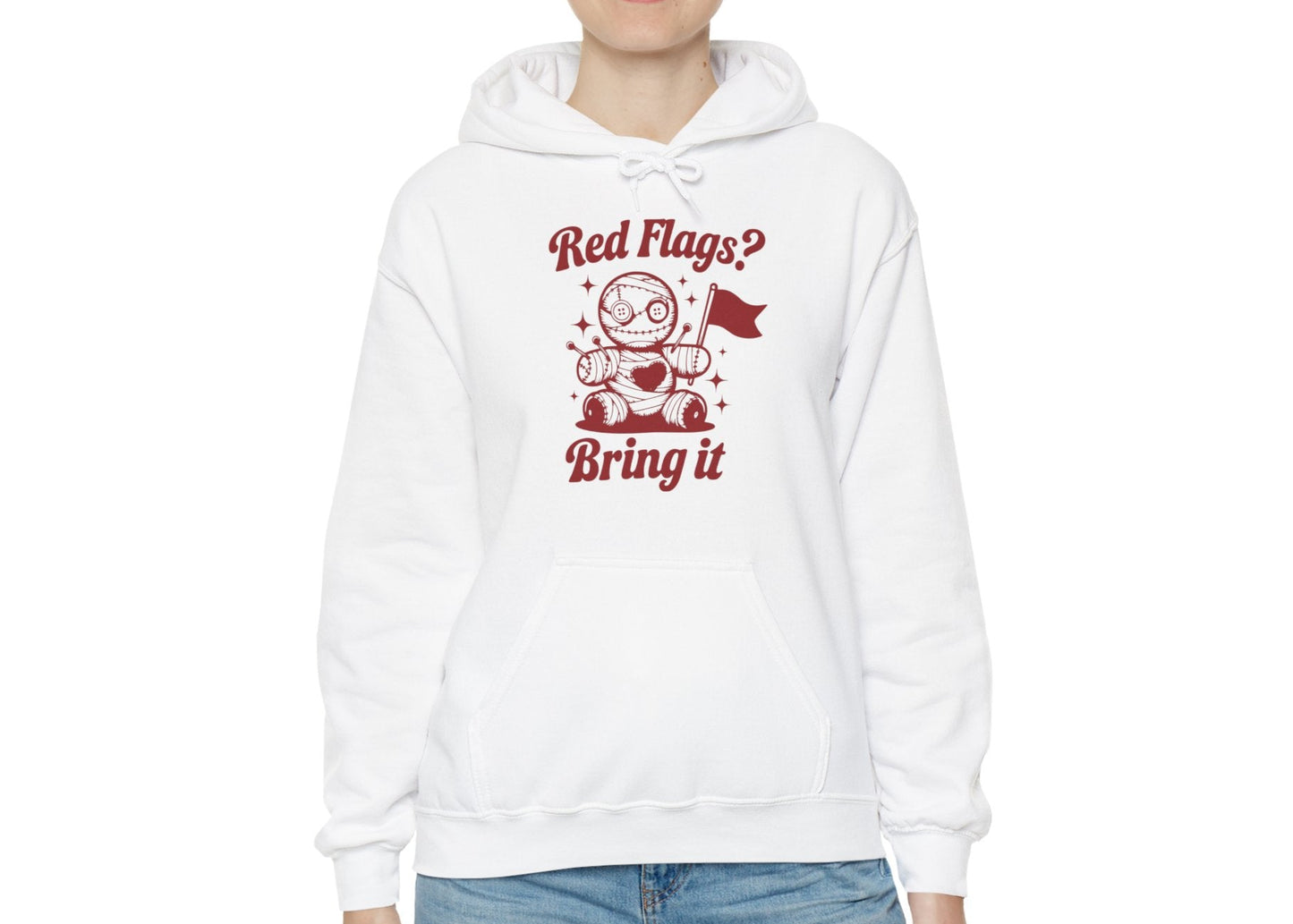 Model wearing a white hoodie featuring "Red Flags? Bring It" text and a cute voodoo doll holding a red flag. Exclusive release for Valentine's Day. Part of the Vivid Divergence Sensory Friendly Sweaters Range.