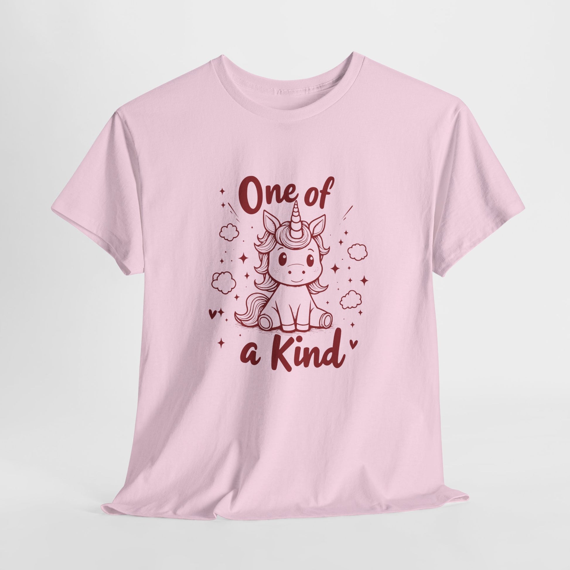 Hanging view of a pink T-shirt featuring the "One of a Kind" design with a doodle-style unicorn surrounded by hearts and sparkles. Part of the Vivid Divergence Sensory Friendly Unisex Tees Range.