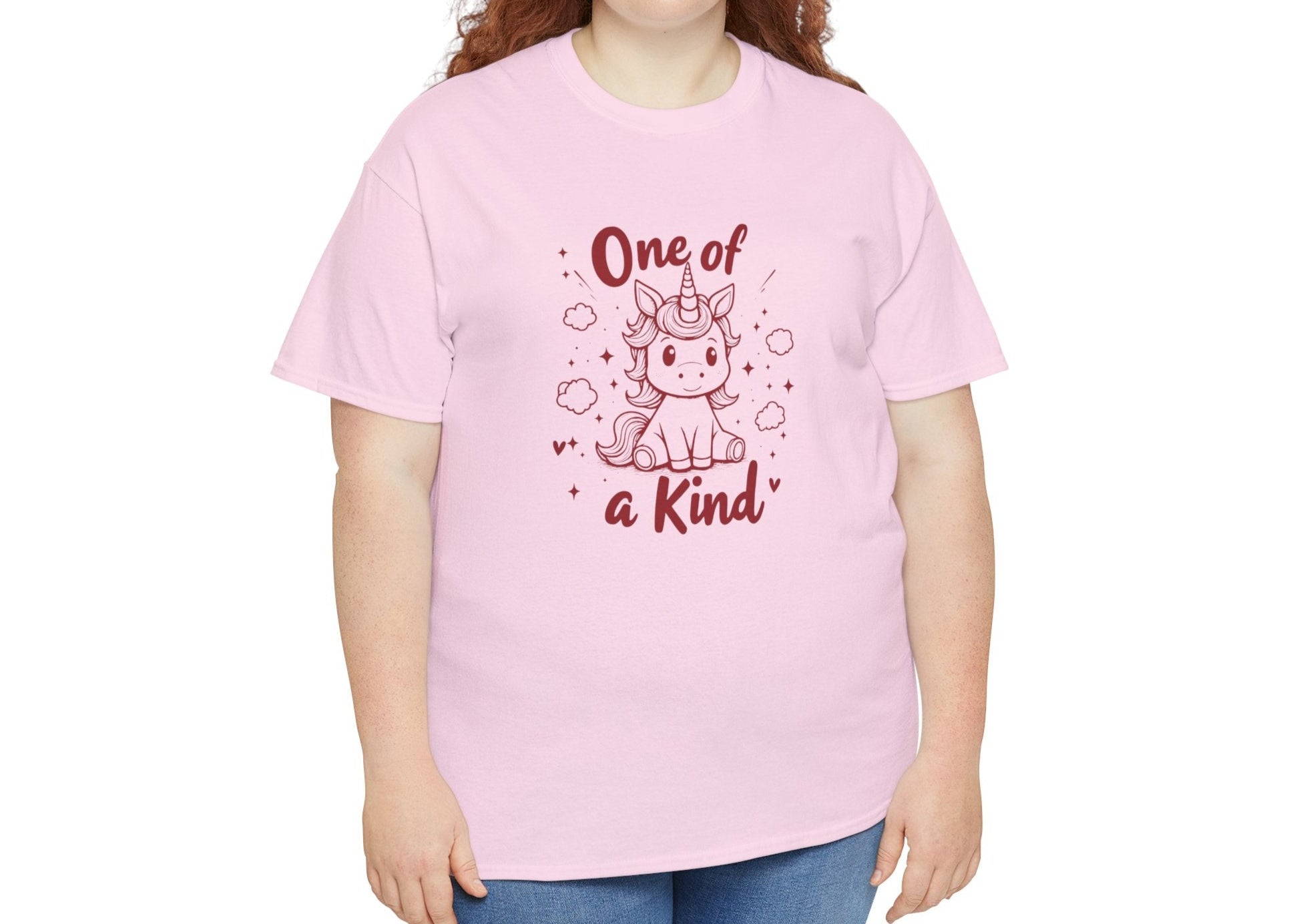 Modeled view of a pink T-shirt featuring the "One of a Kind" design with a doodle-style unicorn surrounded by hearts and sparkles. Part of the Vivid Divergence Sensory Friendly Unisex Tees Range.