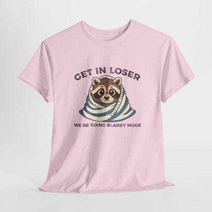 Hanging front view of a pink T-shirt featuring a cute raccoon wrapped in a blanket with text that reads "Get In Loser, We're Going Blanky Mode." Part of the Vivid Divergence Sensory Friendly Unisex Tees Range.