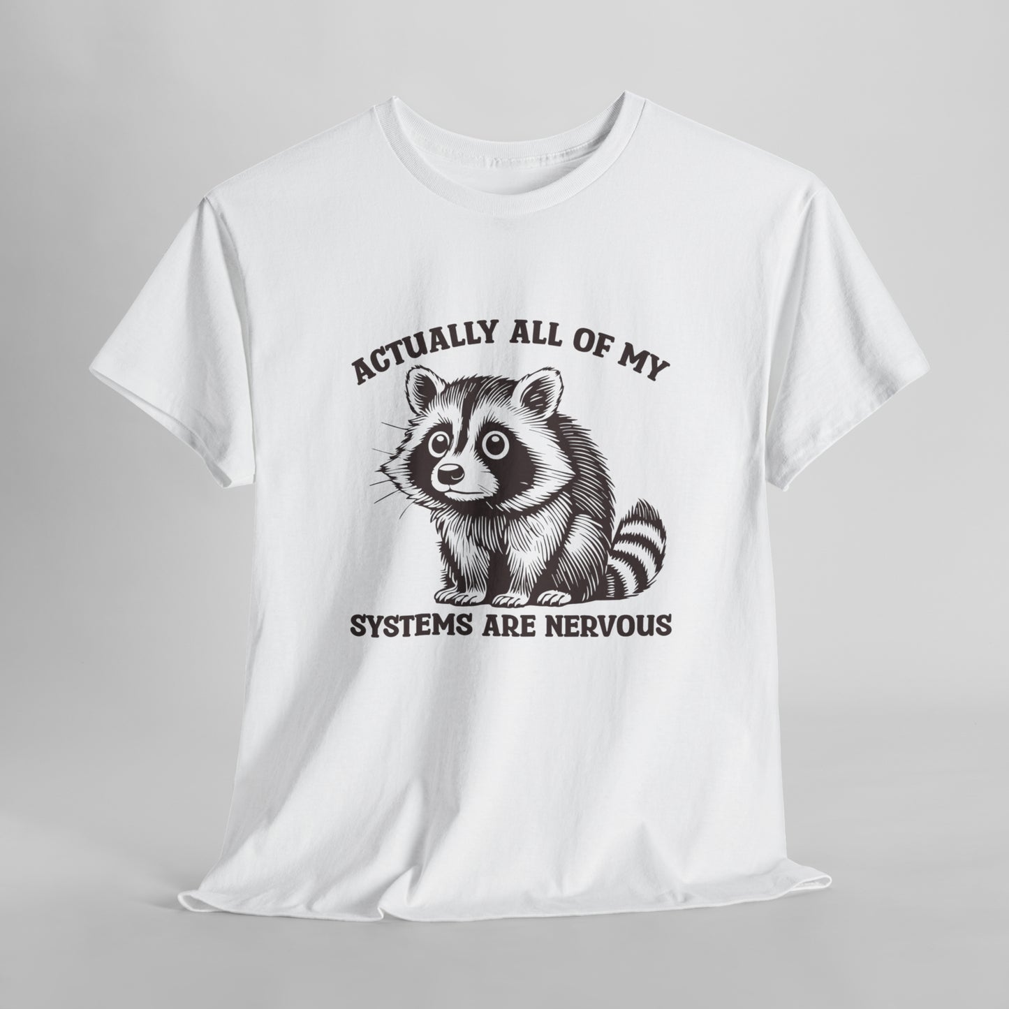 Front hanging view of a white T-shirt with "Actually All Of My Systems Are Nervous" text and a raccoon graphic. Part of the Vivid Divergence Sensory Friendly Unisex Tees Range.