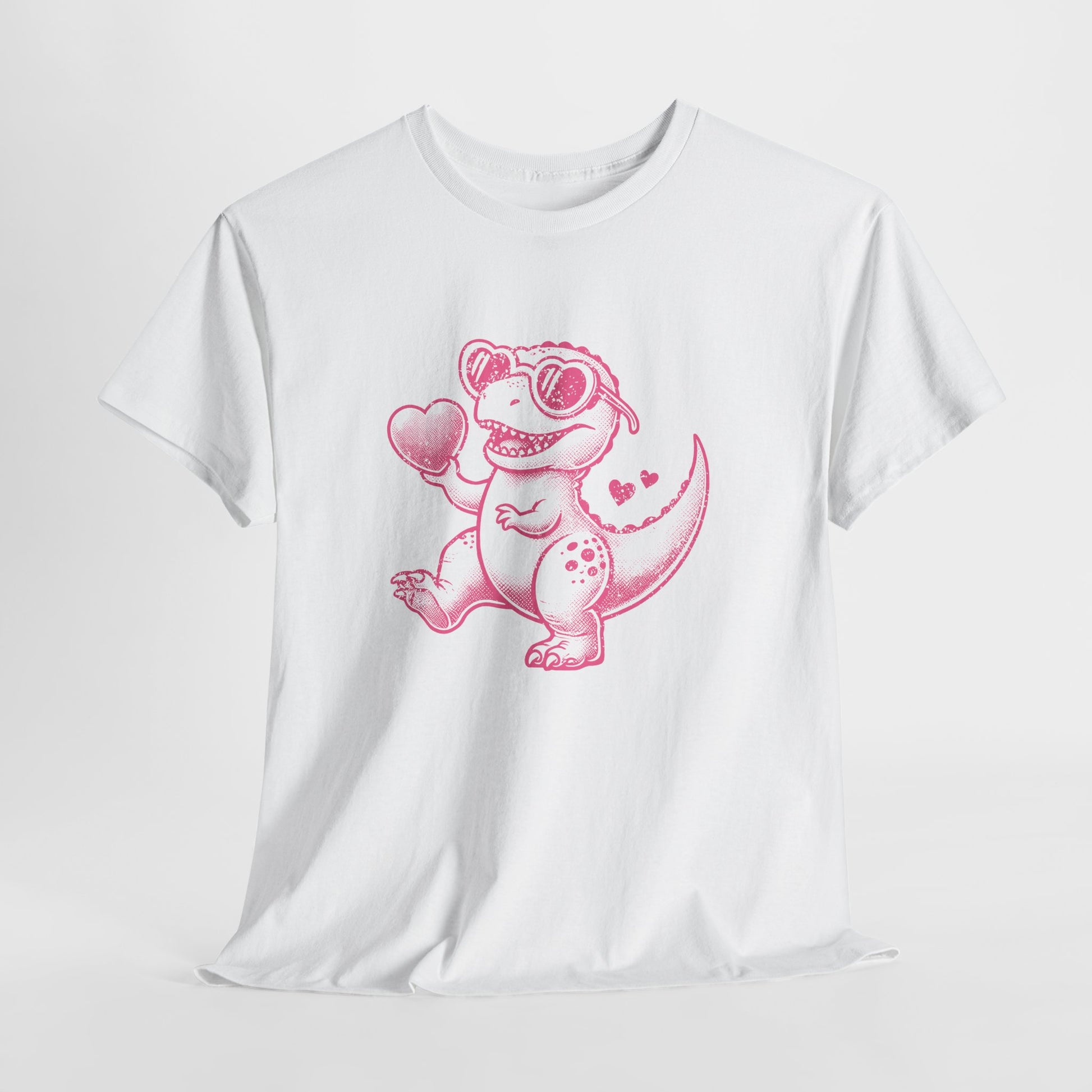 Front view of a white T-shirt featuring a bright pink cartoon dinosaur holding a heart, designed for Valentine’s Day. Exclusive release for Valentine’s Day. Part of the Vivid Divergence Sensory Friendly Unisex Tees Range.