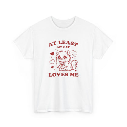 Front view of a white T-shirt with red text and cat illustration that reads "At Least My Cat Loves Me." Exclusive release for Valentine’s Day. Part of the Vivid Divergence Sensory Friendly Unisex Tees Range.