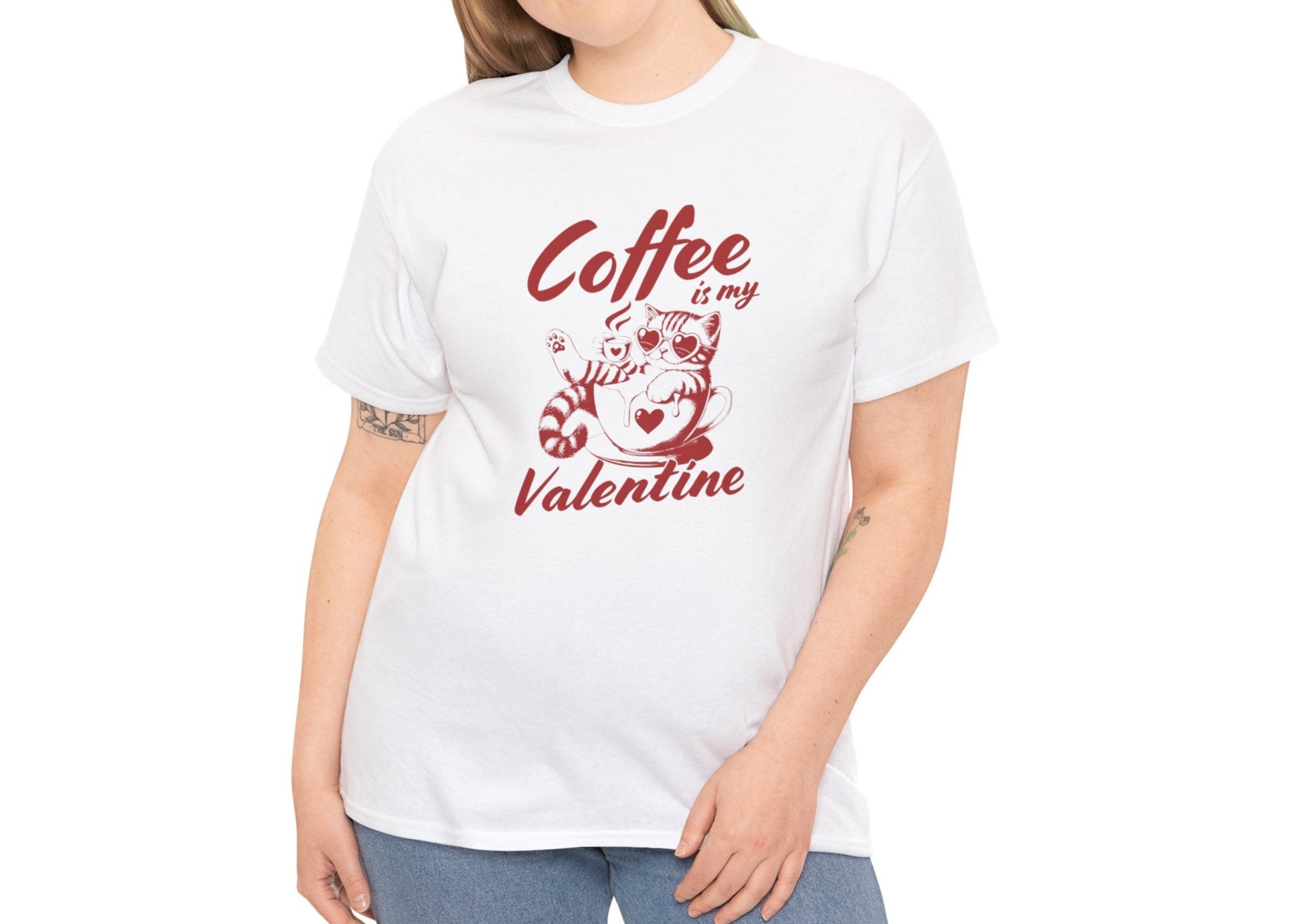 Woman wearing a white T-shirt with red text and cat illustration holding a coffee cup that reads "Coffee Is My Valentine." Exclusive release for Valentine’s Day. Part of the Vivid Divergence Sensory Friendly Unisex Tees Range.