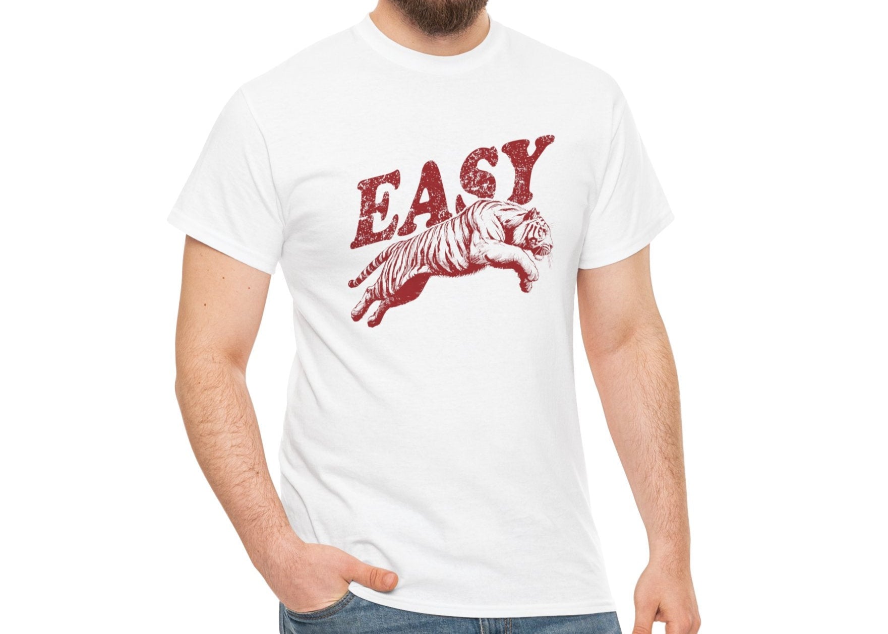 Person wearing a white T-shirt with "EASY" text and tiger illustration in red, shown from a front angle with hands in pockets. Part of the Vivid Divergence Sensory Friendly Unisex Tees Range.