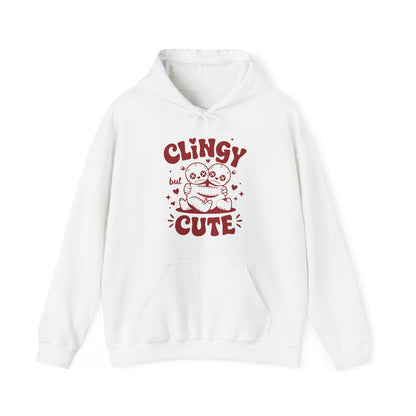 Front view of a white hoodie with "Clingy but Cute" text and a cute voodoo doll design in red. Exclusive release for Valentine's Day. Part of the Vivid Divergence Sensory Friendly Sweaters Range.