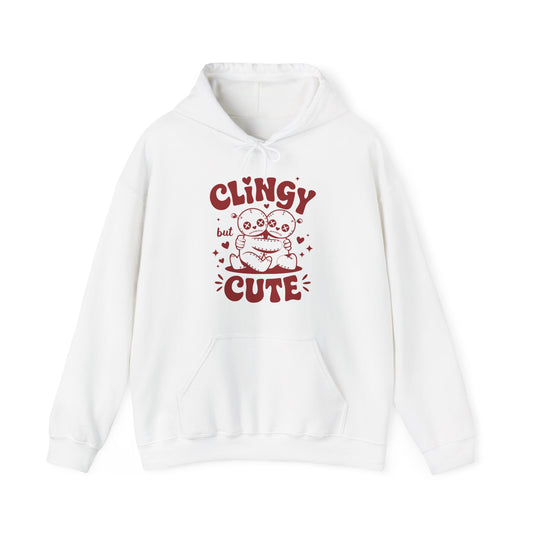 Front view of a white hoodie with "Clingy but Cute" text and a cute voodoo doll design in red. Exclusive release for Valentine's Day. Part of the Vivid Divergence Sensory Friendly Sweaters Range.