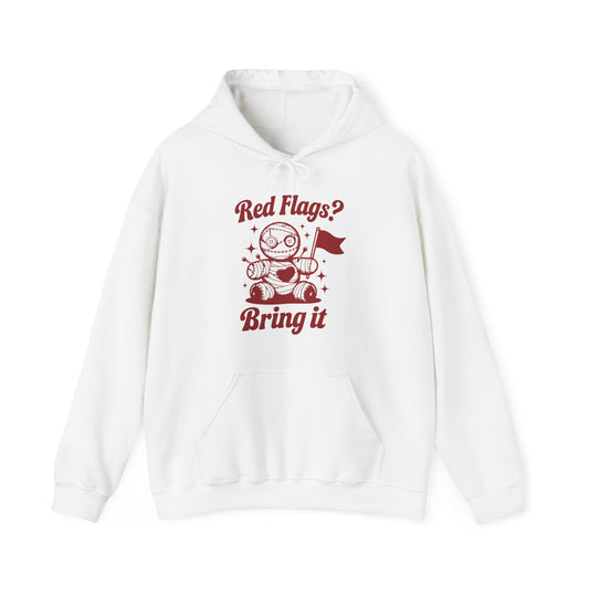 Front view of a white hoodie featuring "Red Flags? Bring It" text and a cute voodoo doll holding a red flag. Exclusive release for Valentine's Day. Part of the Vivid Divergence Sensory Friendly Sweaters Range.