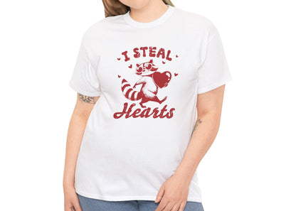 Woman wearing a white T-shirt with red text and raccoon illustration holding a heart that reads "I Steal Hearts." Exclusive release for Valentine’s Day. Part of the Vivid Divergence Sensory Friendly Unisex Tees Range.