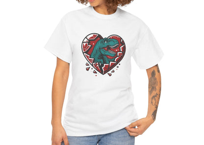 Woman with curly hair wearing a white T-shirt featuring a green dinosaur inside a cracked red heart with small black hearts around it. Exclusive release for Valentine’s Day. Part of the Vivid Divergence Sensory Friendly Unisex Tees Range.