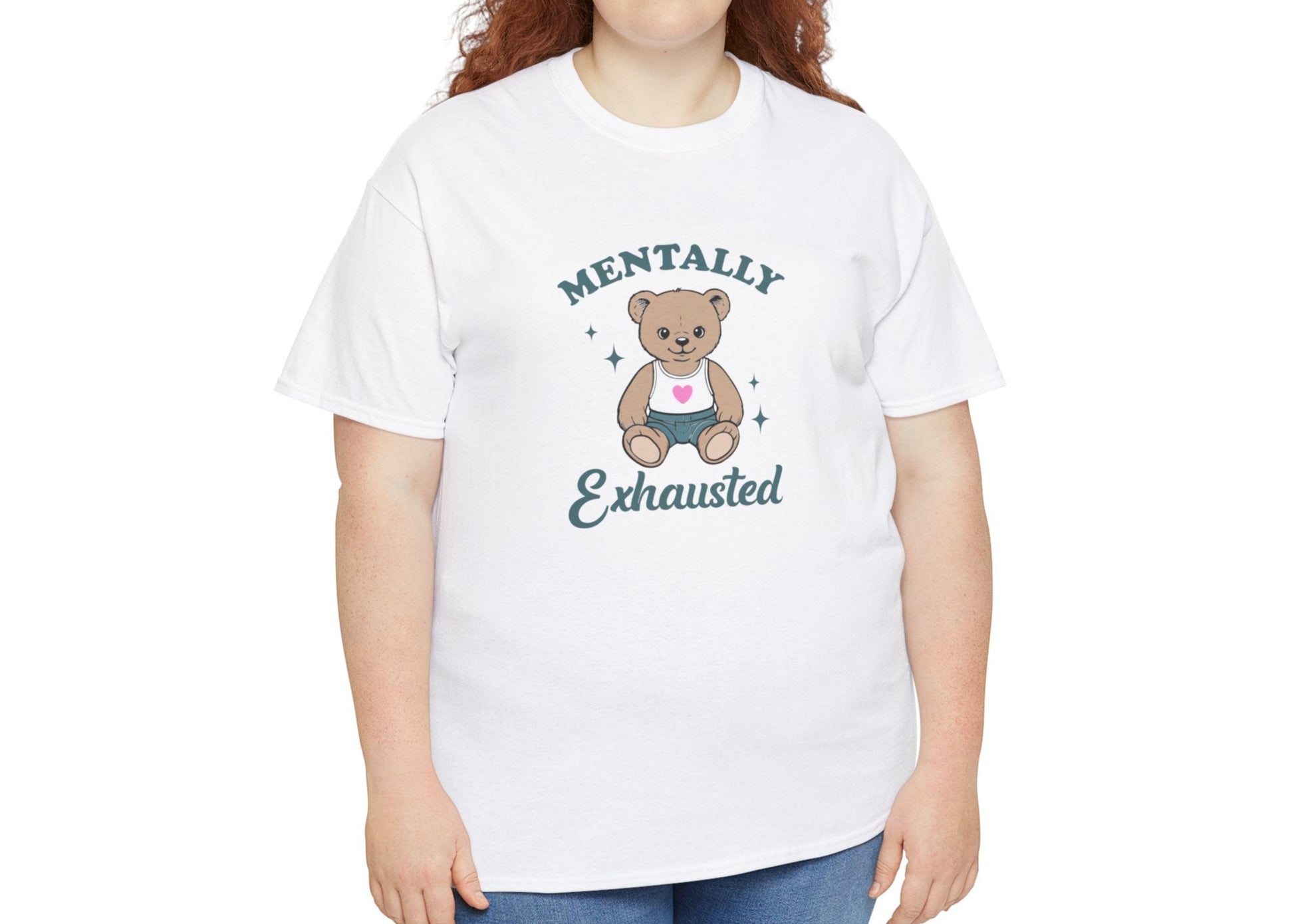 Modeled view of a white T-shirt featuring a teddy bear graphic with the text "Mentally Exhausted." Part of the Vivid Divergence Sensory Friendly Unisex Tees Range.