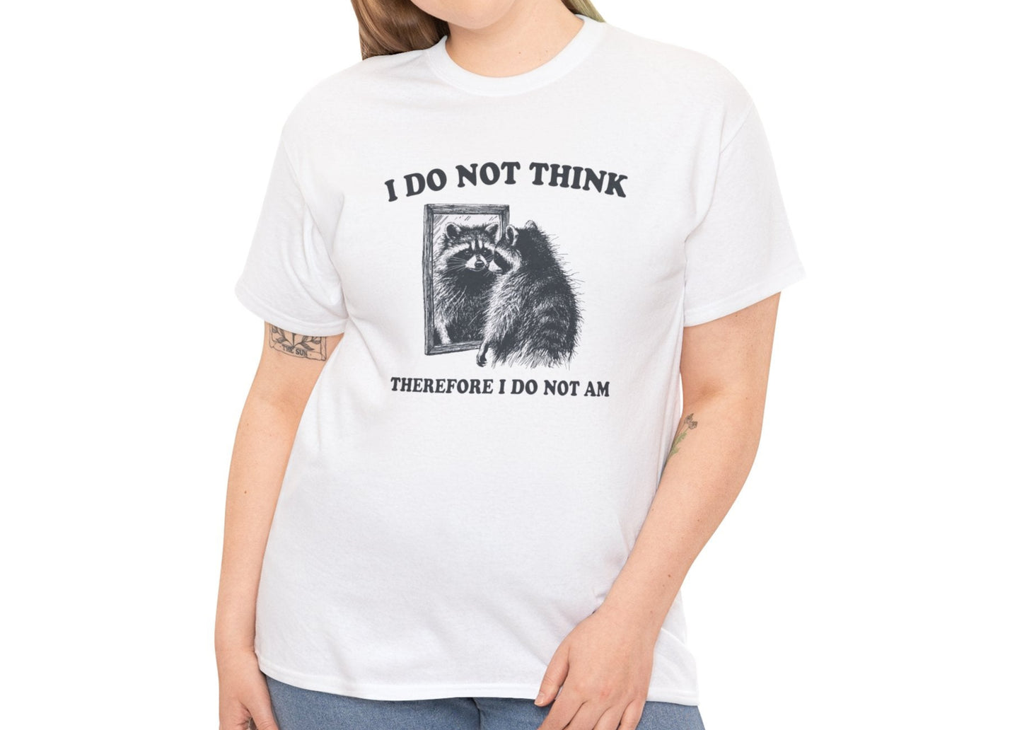 A white T-shirt with a raccoon illustration and existential quote, modeled by a woman. Part of the Vivid Divergence Sensory Friendly Unisex Tees Range. 