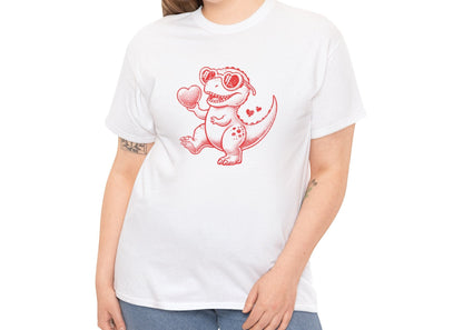 Woman wearing a white T-shirt featuring a red cartoon dinosaur holding a heart, designed for Valentine’s Day. Exclusive release for Valentine’s Day. Part of the Vivid Divergence Sensory Friendly Unisex Tees Range.