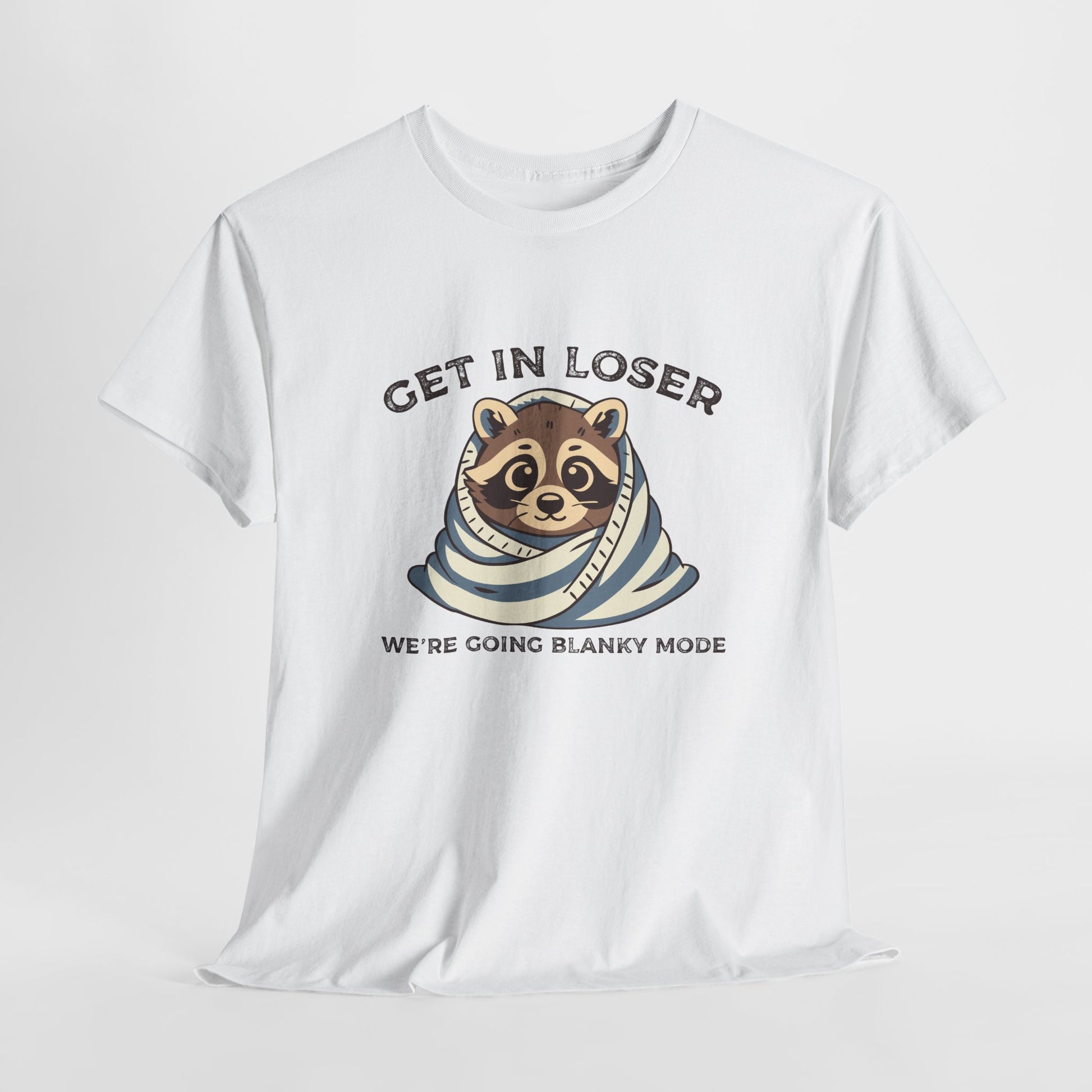 Hanging front view of a white T-shirt featuring a cute raccoon wrapped in a blanket with text that reads "Get In Loser, We're Going Blanky Mode." Part of the Vivid Divergence Sensory Friendly Unisex Tees Range.